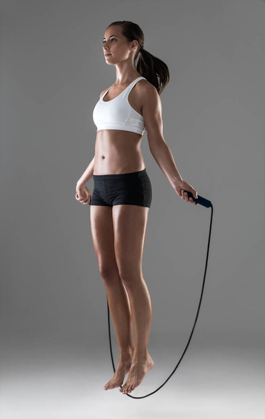 She never skips a workout. Full length shot of a young woman skipping - Foto, imagen