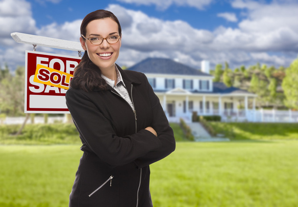 Mixed Race Woman in front of House and Sold Sign
 - Фото, изображение