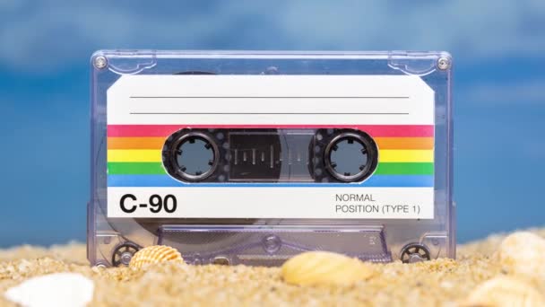 A retro cassette tape on a beach  - Footage, Video
