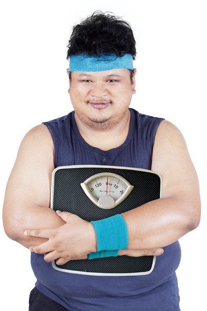 Overweight person holding weight scale - Foto, imagen