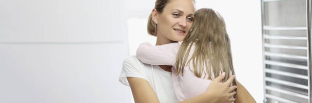 Portrait of mother and daughter hugging, mother comfort daughter in arms. Quality time with parent, kindness and comfort. Family relationship, love concept - Photo, Image