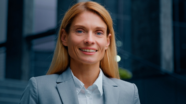 Headshot inspired motivated successful businesswoman professional manager lawyer leader looking at camera smiling attractive happy caucasian woman satisfied customer standing on street posing outdoors - Zdjęcie, obraz