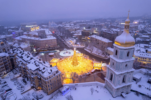 Christmas tree with lights outdoors at night in Kiev. Sophia Cathedral on background. New Year Celebration - Photo, Image