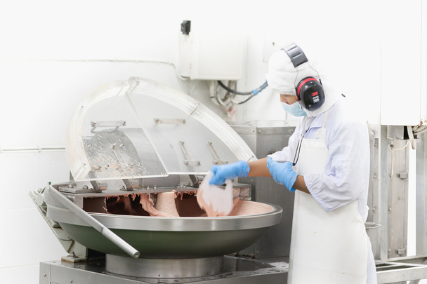 butcher mixxing ingrediant on mechine for meat ball - Photo, Image