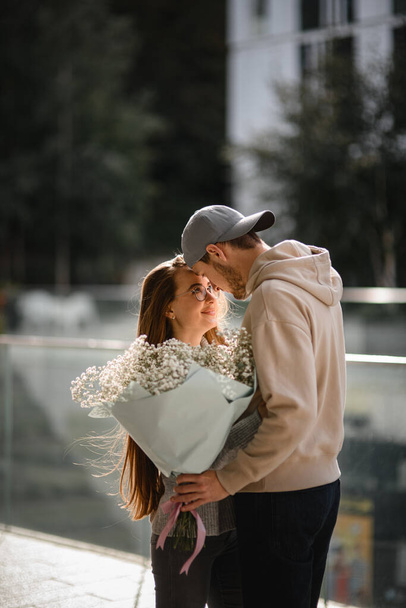 Beautiful view of handsome couple in love, girlfriend and boyfriend, lovely looking at each other. Romantic date. Love story - Фото, изображение