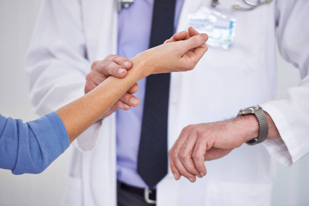 Youll be just fine. a doctor and holding his patients wrist - Photo, Image