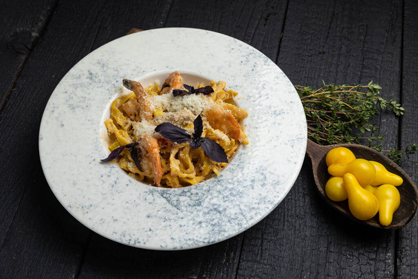 delicious pasta on a dark table in a restaurant - Photo, Image