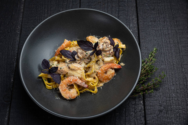 delicious pasta on a dark table in a restaurant - Foto, immagini