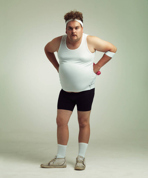 Who you calling fat. Portrait of an overweight man standing with his hands on his hips - 写真・画像