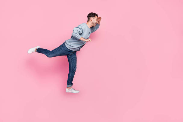Full size photo of handsome young guy carry cart searching shopping promo dressed trendy blue garment isolated on pink color background. - Φωτογραφία, εικόνα