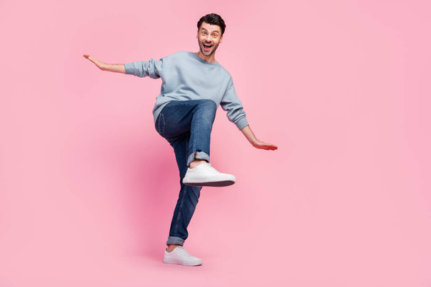 Full size photo of young funny grimace excited guy student wear grey jumper jeans crazy dance celebrate salary holidays isolated on pink color background. - 写真・画像