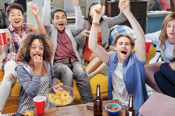 Food, party and watching tv with friends in living room for sports games, winner and goal with global Fifa world cup. Diversity, support and wow with soccer fans for television, news and broadcast. - Photo, Image