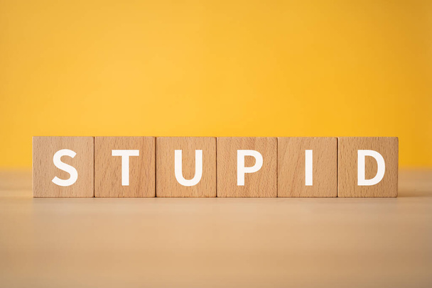 Wooden blocks with "STUPID" text of concept. - Foto, Imagem