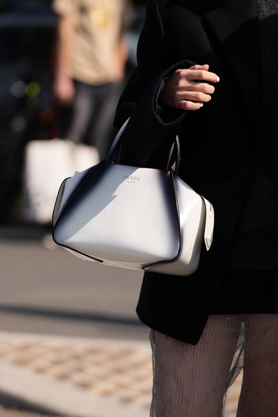 Milan, Italy - September, 22, 2022: woman wearing white and black Supernova small bag from Prada, street style outfit details - Photo, Image