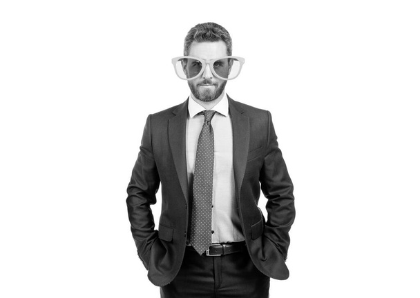 Serious professional man in funny sunglasses and formal suit with hands in pockets isolated on white, businessman. - Photo, image