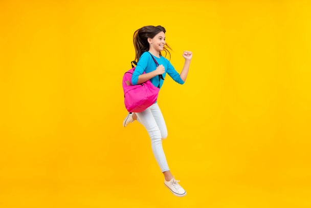School girl with backpack. Teenager student, isolated background. Learning and knowledge. Go study. Run and jump. Children education concept. Happy teenager portrait. Smiling girl - Foto, imagen