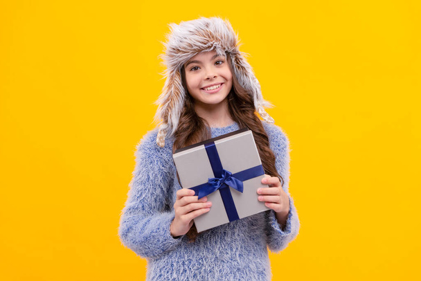 glad teen girl wear earflap hat with purchase ox on yellow background, anniversary. - Фото, изображение