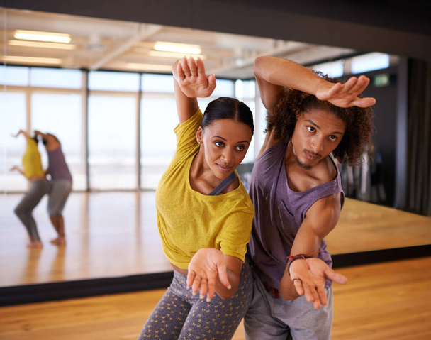 Workinh together towards a perfect performance. two young people practicing in a dance studio - Valokuva, kuva