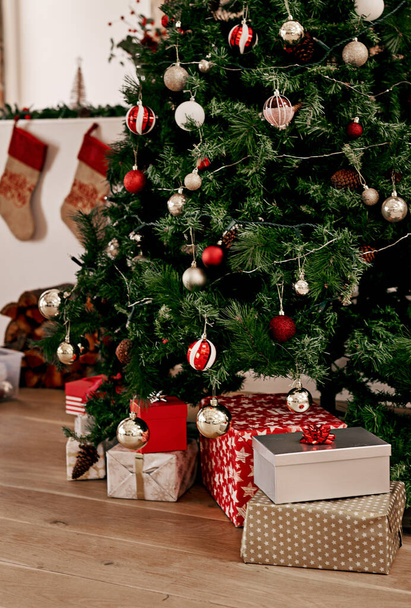 Christmas, tree and gift on the floor of a home living room in celebration or preparation for the festive season. Morning, present and tradition with a Christmas tree in a house for xmas holidays. - Zdjęcie, obraz