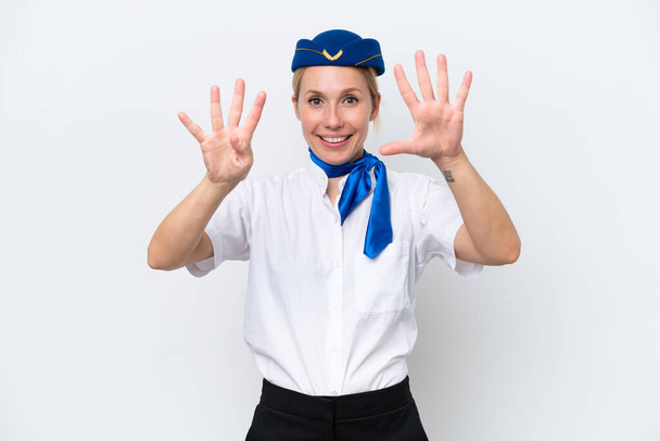 Samolot blondynka stewardessa kobieta izolowany na białym tle licząc dziewięć z palcami - Zdjęcie, obraz