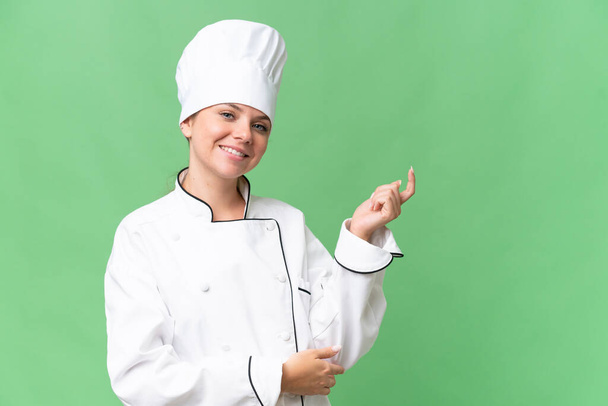 young chef woman over isolated green background  - Photo, Image