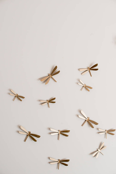Flock of golden dragonflies on a wall. Home decor - Fotoğraf, Görsel