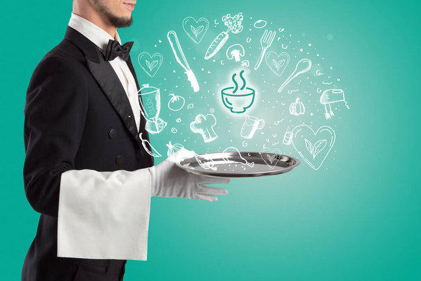 Waiter holding silver tray with soup icons coming out of it, health food concept - Photo, Image