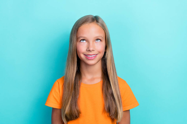 Close up photo of pretty adorable girl wear orange outfit look empty space banner cool offer proposition isolated on cyan color background. - Фото, изображение
