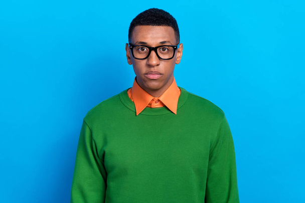 Portrait of serious confident guy dressed orange shirt under green pullover eyewear look at camera isolated on blue color background. - Fotó, kép