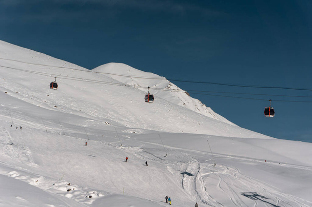 happy tourists on skilift at snowy alps - Photo, Image