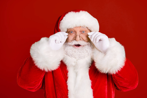 Portrait astonished santa claus impressed x-mas newyear christmas magic miracle advent sales discount touch white gloves specs wear red headwear isolated bright shine color background - Photo, Image