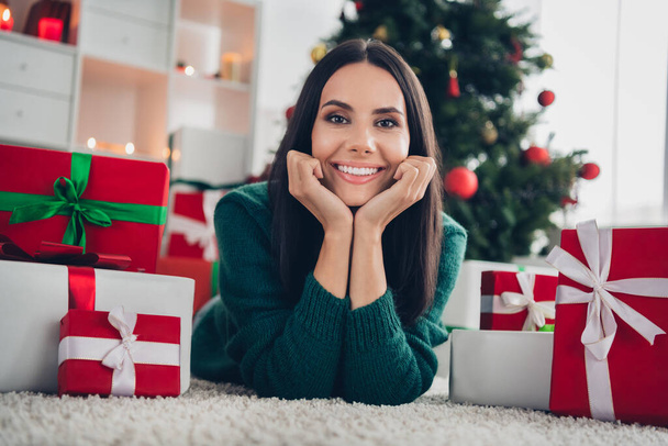 Photo of adorable sweet girl wear xmas green pullover lying floor arms cheeks indoors home room. - Photo, Image