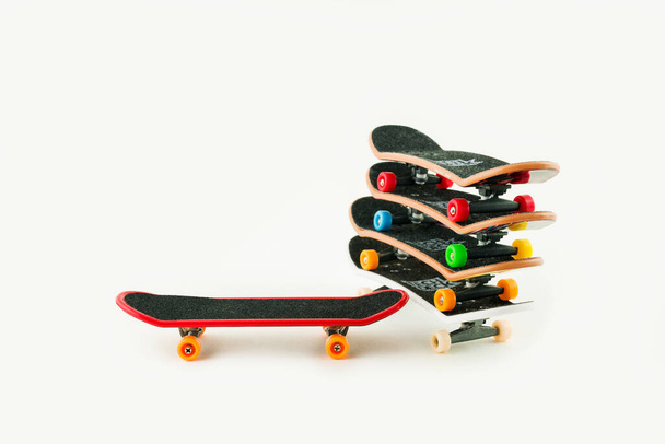 Office entertainment. Fingerboard  a skateboard on white backgro - Photo, Image