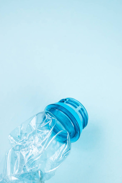 Close up of plastic stripped bottle on blue background - Zdjęcie, obraz