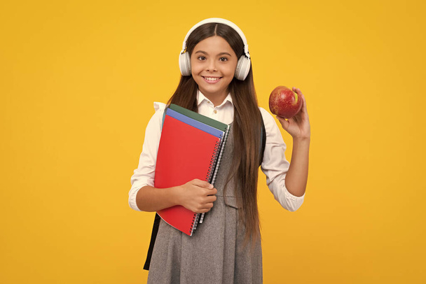 School teen girl in headphones and books, copy space, back to school. Happy girl face, positive and smiling emotions - Fotoğraf, Görsel