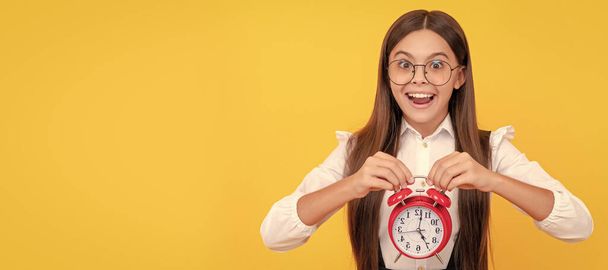 school kid in uniform and glasses showing time. you are late. deadline. good morning. Teenager child with clock alarm, horizontal poster. Banner header, copy space - Fotoğraf, Görsel