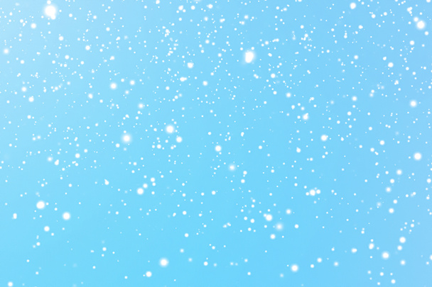 Winter holidays and wintertime background, white snow falling on blue backdrop, snowflakes bokeh and snowfall particles as abstract snowing scene for Christmas and snowy holiday design. High quality - Photo, Image