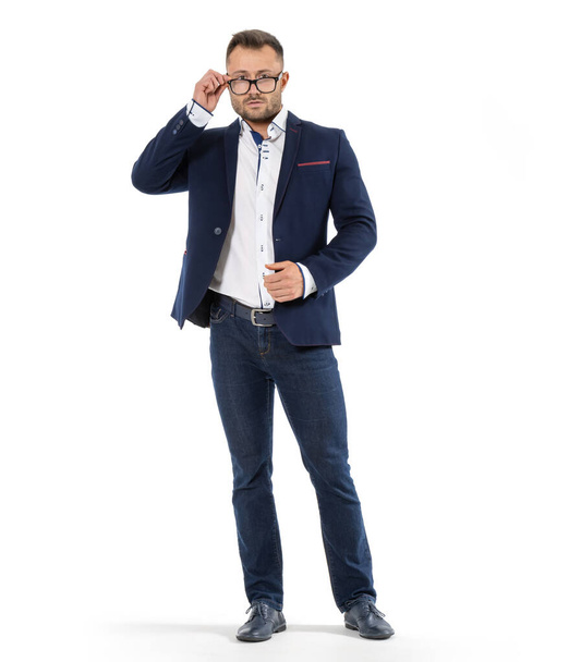 Business man in a jacket and glasses looks directly into the camera. It stands to its full height. - Fotografie, Obrázek