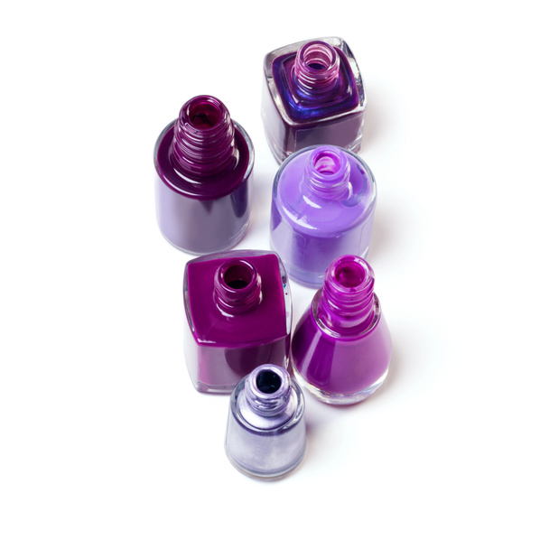 You can never have too much purple in your life. Studio shot or a variety of purple-hues nail varnish bottles - 写真・画像