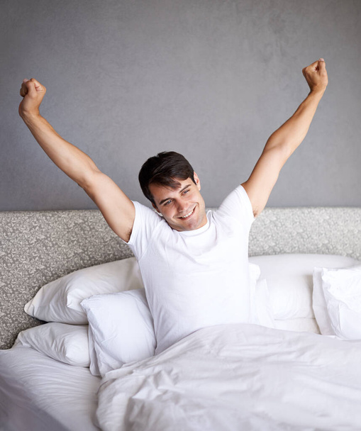 That was the best sleep ever. a young man stretching in bed while waking up - Φωτογραφία, εικόνα