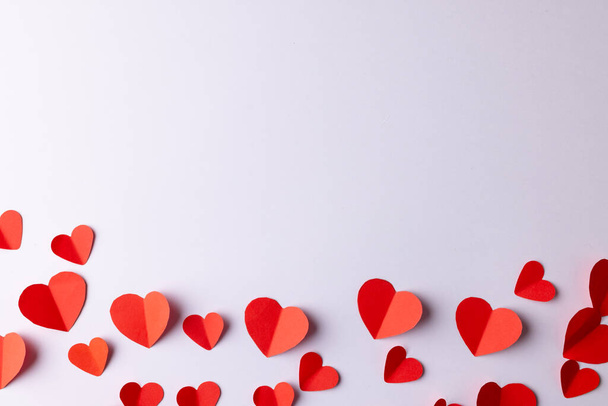 Red paper heart shapes on white background with copy space. Valentine's day, love, romance and celebration concept. - Fotografie, Obrázek