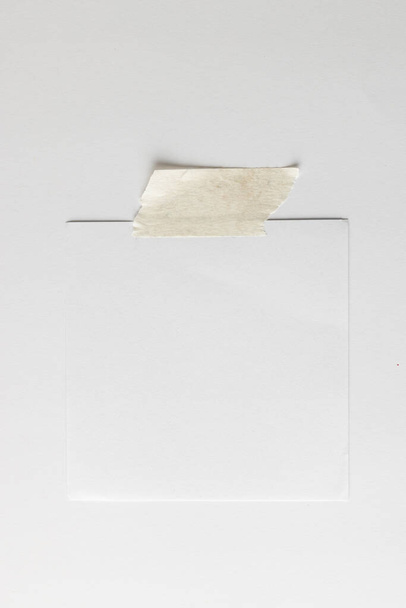 White sticky memo note with tape and copy space on white background. Abstract paper texture background and communication concept. - Фото, зображення