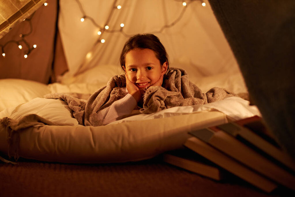 Θα κοιμηθώ σε δικό μου σπίτι. Ένα χαρούμενο κοριτσάκι σε ένα οχυρό με κουβέρτες. - Φωτογραφία, εικόνα
