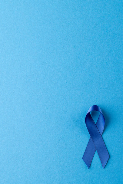 Vertical of blue ribbon for prostate cancer awareness, on blue background with copy space. Medicine, healthcare and health awareness concept. - Foto, imagen