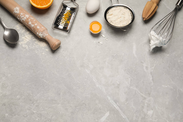 Flat lay composition with different tools for cooking on light grey marble table. Space for text - Фото, зображення