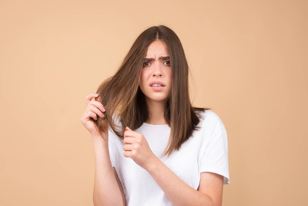 Sad woman with hair loss problem worried about hair loss - Foto, afbeelding
