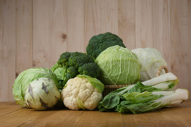 Many different types of fresh cabbage on wooden table - 写真・画像