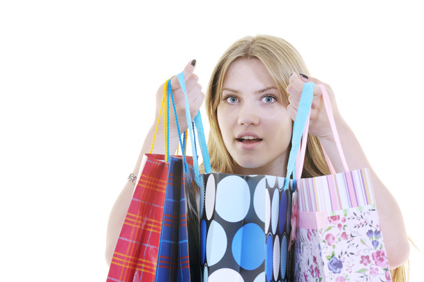 Happy young adult women shopping with colored bags - Photo, image