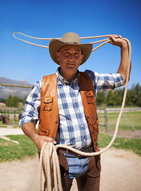 Showing his skill with a lasso. a man with a lasso on the farm - Photo, Image