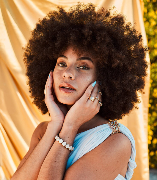 Summer, fashion and portrait of black woman in garden with natural beauty, cosmetics and makeup on face. Skincare, wellness and girl with yellow fabric or silk sheet outdoors and designer jewellery. - 写真・画像